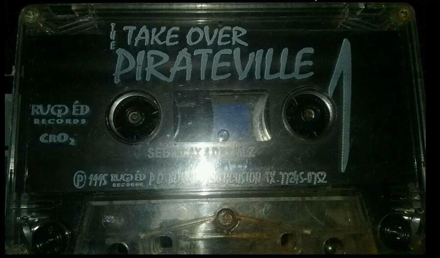 An original cassette copy of “Pirateville,” reflecting the independent distribution methods of The Takeover during the 1990s.